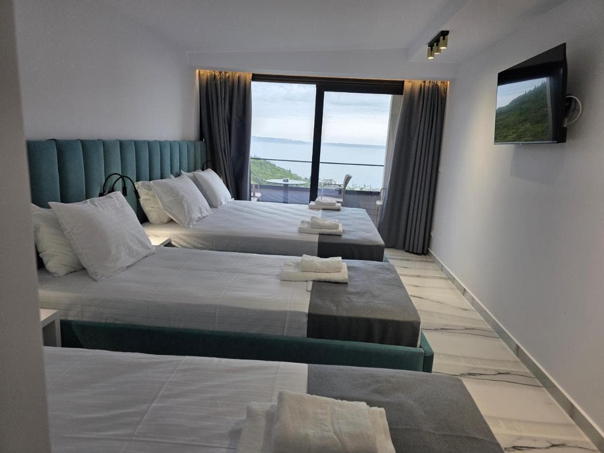 Family suite with three beds and a sea-view balcony